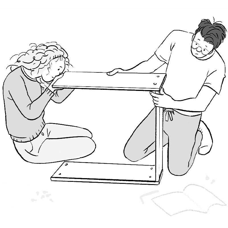 two humans building flat-pack furniture together